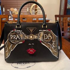 Hand Painted By An Artist Gorgeous Prada Bag Excellent Condition- It’s Exclusive Peace Worn Only Few Times Designer Saffiano Leather Shoulder Bag, Black Saffiano Leather Shopping Bags, Black Luxury Saffiano Leather Shoulder Bag, Luxury Black Saffiano Leather Shoulder Bag, Designer Black Saffiano Leather Shoulder Bag, Designer Saffiano Leather Shoulder Bag With Handles, Designer Saffiano Leather Evening Bag, Designer Gold Saffiano Leather Shoulder Bag, Prada Nylon Tote Bag