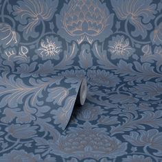 a blue and gold wallpaper with an intricate design on the bottom half of it