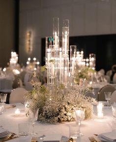 the centerpiece is surrounded by candles and flowers