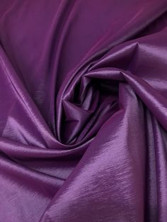 a close up shot of the purple fabric that is very soft and shiny in this image