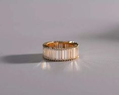 a white and gold ring sitting on top of a table