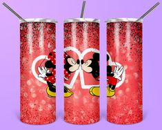 three minnie mouse tumblers with straws in front of a purple background, one has a heart and the other has a mickey mouse on it's face