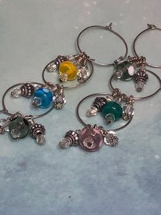 four wine glass charms sitting on top of a table