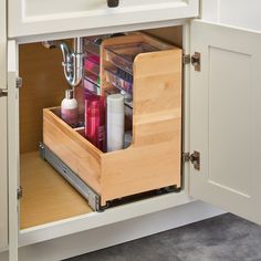 an open drawer in a kitchen filled with beauty products