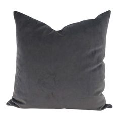 a dark gray pillow on a white background