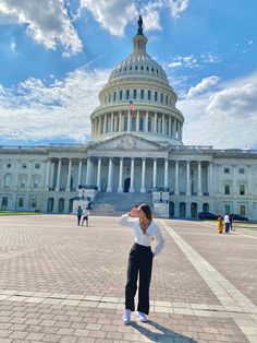 a woman standing in front of the capitol building