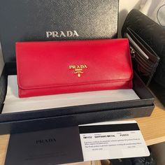 This Red Prada Wallet Is In Brand New Condition, Received As A Gift Many Years Ago And Sitting In Closet, Unused. It Comes With All Original Packaging, Prada Shopping Bag, Box, Authenticity Card. Brand New Is Over $960 With Tax. Snap Closure Metal Lettering Logo Two Bill Compartments Ten Card Slots Four Interior Pockets Internal Coin Pocket With Zipper External Coin Pocket With Zippe Height: 9.5cm Width: 18.7cm Link The Prada Site For More Details On This Wallet: Https://Www.Prada.Com/Us/En/Wome Prada Wallet Aesthetic, Luxury Red Leather Wallet, Designer Red Wallet For Travel, Elegant Red Wallet With Interior Card Slots, Red Leather Evening Wallet, Red Rectangular Wallet, Designer Red Evening Wallet, Designer Red Wallet With Interior Card Slots, Designer Red Wallets With Interior Card Slots