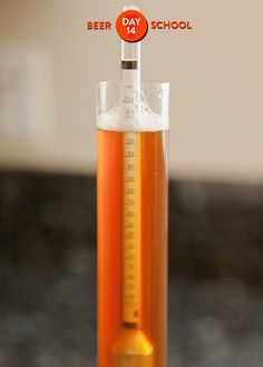 a glass filled with liquid sitting on top of a counter