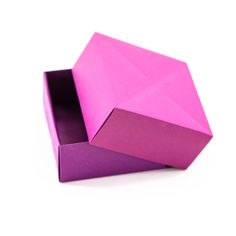 an open pink box sitting on top of a white table next to a purple object