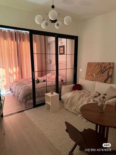 a living room filled with furniture and a sliding glass door leading to a bedroom area