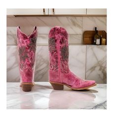 Add a touch of country charm to your wardrobe with the Laredo Women's Paislee Western Boots. These boots feature a stylish snip toe design that adds a touch of sophistication. The pull-on style with pull tabs makes it easy to slip on and off while the 12" shaft height provides a classic western look. The 2.5" western heel adds a subtle lift, and the single-stitch welt construction ensures durability. The solid pink design is elevated by the purple floral overlay, which adds a pop of color and pe Fitted Country Boots With Round Toe, Fitted Country Style Boots With Round Toe, Country Style Boots For Ranch In Spring, Country Style Boots For Spring Ranch, Country Style Boots For Spring Country Events, Country Style Boots With Round Toe For Country Events, Fitted Boots For Country Events In Spring, Fitted Boots For Spring Country Events, Fitted Casual Boots For Country Events