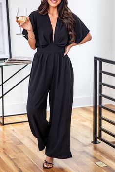 Material: 100%Polyester Make a bold fashion statement with this Deep V Neck High Waist Wide Leg Jumpsuit that exudes confidence and style. The deep V-neckline, high waist, and wide leg create a modern and elegant silhouette that flatters all body types perfectly.The light fabric of this jumpsuit provides incredible comfort, allowing you to wear it all day without feeling weighed down. The high waist and wide-leg design keep you comfortable and feeling confident no matter what your day brings.... V-neck Solid Color Jumpsuit For Party, Elegant V-neck Jumpsuits And Rompers For Going Out, Summer V-neck Jumpsuits And Rompers For Going Out, Black V-neck Jumpsuit, Elegant V-neck Jumpsuit For Date Night, Chic High Waist Jumpsuits And Rompers, Non-stretch V-neck Jumpsuit For Night Out, Non-stretch V-neck Jumpsuits And Rompers For Night Out, V-neck Non-stretch Jumpsuits For Night Out