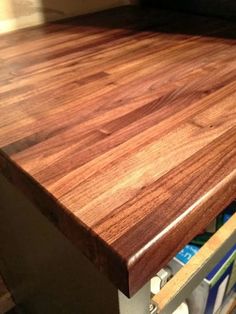 a wooden counter top with drawers underneath it