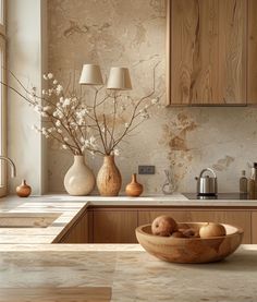 a wooden bowl filled with fruit on top of a counter