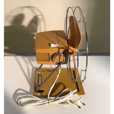 an orange and white object sitting on top of a table next to a charger