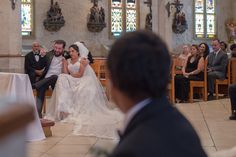 the bride and groom are sitting at the alter