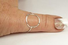 A hammered circle ring made with 18 gauge wire. Modern and simple minimal jewelry.Made with sterling silver Handmade and polished to a high shine in my shop.The circle symbol meaning is universal, sacred and divine. It represents the infinite nature of energy, and the inclusivity of the universe.Purity ring, karma ring,  midi ring modern and simplesize 4-13 1/2  if you need a different size just put that in notes to seller or convo me.sterling silver ring Minimalist Hammered Sterling Silver Midi Rings, Hammered Sterling Silver Midi Rings, Silver Hammered Minimalist Midi Rings, Simple Hammered Rings, Hand Forged Sterling Silver Stackable Rings, Simple Silver Round Midi Rings, Silver Hammered Midi Rings, Handmade Simple Sterling Silver Midi Rings, Karma Ring