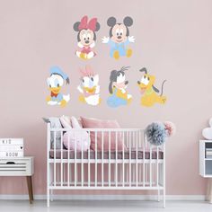 a baby's room with mickey mouse wall decals