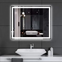 a bathroom sink sitting under a large mirror