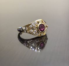 DeKara Designs Collection Metal- 18K Yellow Gold, .750. Stones- 1 Oval Ruby 0.50, 28 Round Diamonds G Color VS2 Clarity 0.22 Carats. Art Deco 18K Yellow Gold Ruby Diamond Engagement Ring. This ring features a beautiful reddish pink ruby that is half carat total weight, surrounded by 28 round diamonds. The center ruby is bezel set, 20 pave set diamonds, and 8 bezel set diamonds. The ring is entirely handmade, and could be hand engraved for an additional $200.00. The ring is a size 6 1/2, and coul Oval Yellow Gold Ruby Ring For Ceremonial Occasions, Formal Yellow Gold Ruby Ring With Single Cut Diamonds, Luxury Gold Ruby Ring With Single Cut Diamonds, Exquisite Yellow Gold Ruby Wedding Ring, Exquisite Gold Ruby Wedding Ring, Exquisite Yellow Gold Ruby Ring For Wedding, Exquisite Gold Ruby Ring For Wedding, Traditional Yellow Gold Ruby Ring For Anniversary, Heirloom Gold Ruby Ring With Rose Cut Diamonds