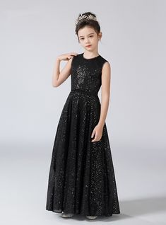 Ephemeral sophistication captures the essence of this exquisite flower girl dress, designed to make your little girl feel like royalty. The sleeveless bodice is adorned with shimmering black sequins that catch the light, creating a dazzling effect. The fitted waist flows into a full, floor-length skirt that sways elegantly with each step, making it perfect for twirling and dancing. Ideal for weddings, formal events, and holiday celebrations, this dress ensures your flower girl will be the center Sparkling Accessories, Black Flower Girl Dress, Black Sequin Shorts, Long Flower Girl Dresses, Blue Tulle, Floor Length Skirt, Black Tulle, Red Sequin, Charm Making