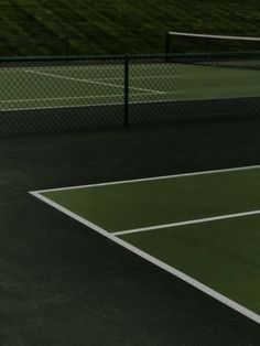 a man standing on top of a tennis court holding a racquet