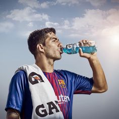 a soccer player drinking water from a bottle