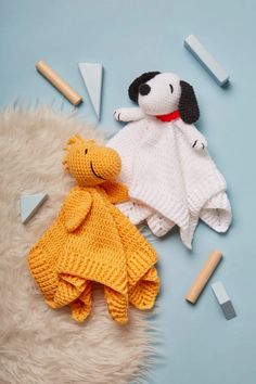 two knitted animals laying next to each other