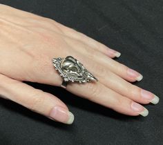 "This richly detailed antiqued silver ring is accented with a raven skull, set in a lovely frame. It measures 1 1/2\" tall and 1\" wide. Ring is adjustable hypoallergenic stainless steel. Matching earrings and pendant are listed in our store." Skull Cameo, Victorian Filigree, Silver Head Piece, Rainbow Topaz, Crow Bird, Antique Silver Rings, Raven Skull, Onyx Crystal, Gothic Victorian