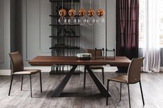 a dining room table and chairs in front of a wine rack