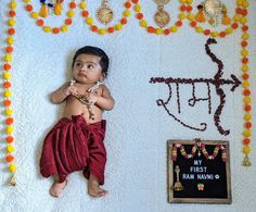 a baby is laying down in front of some decorations