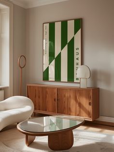 a living room scene with focus on the coffee table and art hanging over the sideboard