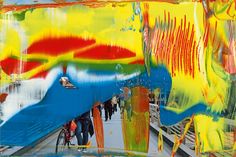 an abstract painting with multiple colors and people walking on the sidewalk in front of it