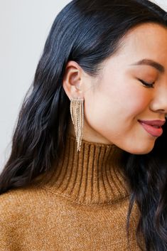 From cocktail hour to date night, the Riley Gold Rhinestone Fringe Earrings has everything you need to create a radiant outfit! These trendy gold earrings feature a stud post back with gold chain fringe + rhinestones! Style the Riley Earrings with a maxi dress + booties for a girly fall look! Gold Plated Rhinestones Fringe Stud Post Back One Size | Length 2.75” Gold Rhinestone Tassel Dangle Earrings, Gold Tassel Dangle Earrings With Rhinestones, Glamorous Gold Fringe Earrings, Glamorous Gold Rhinestone Fringe Jewelry, Glamorous Gold Jewelry With Rhinestone Fringe, Gold Rhinestone Jewelry For Night Out, Gold Chandelier Earrings With Rhinestone Fringe For Evening, Glamorous Gold Tassel Earrings With Rhinestone Fringe, Glamorous Gold Tassel Earrings With Rhinestones