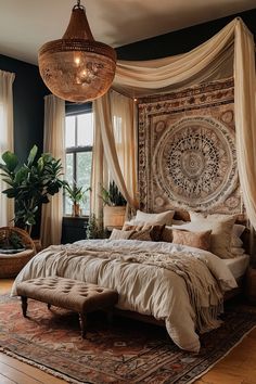 a large bed sitting in a bedroom under a chandelier next to a window