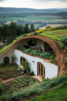 an unusual house with plants growing on the roof