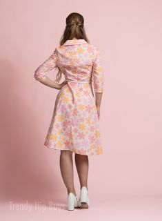 • Embrace timeless elegance with our Vintage Style Dress, evoking the charm of 50s and 60s Dress Style.• This Vintage Inspired Dress features a Pastel Orange, Pink Floral pattern, perfect for adding a touch of vintage flair to your wardrobe.• Crafted from a cotton-like polyester blend, this A-line Dress offers both comfort and style, ideal for all-day wear.• With a wing collar neckline and 3/4 sleeves, this Vintage Shirt Dress Style exudes sophistication, while the knee-length A-line skirt adds Retro A-line Midi Dress For Garden Party, Fitted Vintage Dress For Retro-themed Summer Events, Summer Retro Vintage Dress For Retro-themed Events, Retro Mid-length Summer Dresses, 1950s Style Fitted Dress For Retro-themed Events, Fitted Dresses For 1950s Retro-themed Events, Vintage Dresses For Retro-themed Spring Events, Vintage Dress For Retro-themed Events, Retro Vintage Dress For Retro-themed Events