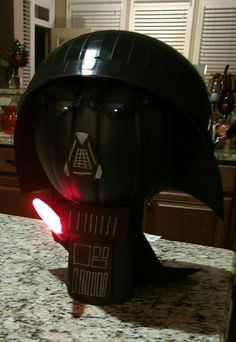 a star wars helmet on top of a counter in a kitchen with the lights on