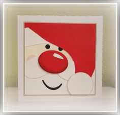 a close up of a christmas card with a santa clause on the front and red nose