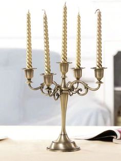 a gold candelabra with five candles on it