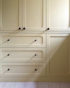 a kitchen with white cabinets and tile flooring