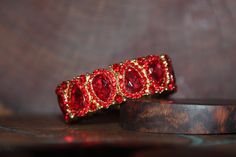 "Beautiful bracelet with red rhinestone crystals, great statement piece! Pageant, prom, or bridal! Size: .75\" wide Style: stretch bracelet color: red crystals Base Metal color: gold Looking for matching earrings or necklace? Browse through our listings or send us a message! :) https://www.etsy.com/listing/551764936/red-rhinestone-necklace-and-earrings-set?ref=shop_home_active_15 https://www.etsy.com/listing/550716625/red-and-ab-rhinestone-earrings-red-large?ref=shop_home_active_50 Looking for t Prom Bracelet, Valentines Bracelets, Blue Crystal Necklace, Jewelry Pearls, Red Bracelet, Gold Bridal Earrings, Prom Earrings, Red Bracelets, Red Prom