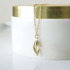 "Beautiful and lovely gold Tulip charm necklace. Made of a matte gold finish Tulip charm with a skinny gold plated brass chain. Soft and simple. Great for gift, everyday or special occasion. Your item will ship in a gift box. Please feel free to contact me if you have any questions. ♥ Length 14\" - 20\" chain ♥ Tulip charm 3/8\" x 5/8\" long ♥ Gold plated over brass ♥ See more Rudiana Accessories Rudiana.etsy.com" Everyday Gold Charm Necklaces With Flower Charm, Minimalist Gold Charm Necklace For Mom, Gold Charm Necklace With Flower Pendant For Birthday, Dainty Gold Plated Flower Necklace For Gift, Gold Minimalist Charm Necklaces With Flower Charm, Minimalist Gold Charm Necklace For Birthday, Minimalist Gold Charm Necklace With Flower Charm, Minimalist Gold Necklace With Flower Charm, Gold Flower Pendant Charm Necklace For Birthday