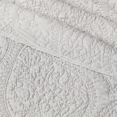 white quilted bedding with an intricate design