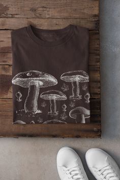 Thanks for stopping by! Cottagecore Mushroom T-shirt Printed on a super soft, cotton tee Dispatched in 5 working days or sooner Unisex Free UK delivery Material: 100% ringspun cotton. Chest (to fit): S  34/36   M  38   L  40/42   XL  44/46   XXL  48/50 ECO-FRIENDLY Each garment is made to order, reducing extra material and energy that would be otherwise wasted We use DTG printing process which is easier on the environment than screen-printing Our ink is bright and also eco-friendly. Do not tumbl Cotton Crew Neck Tops With Mushroom Print, Crew Neck Cotton Shirt With Mushroom Print, Cotton Shirt With Mushroom Print, Cotton Crew Neck Shirt With Mushroom Print, Cotton T-shirt With Mushroom Print, Crew Neck, Cotton Crew Neck T-shirt With Mushroom Print, Cotton Graphic Tee With Mushroom Design, Mushroom Tshirt, Clothing Cottagecore