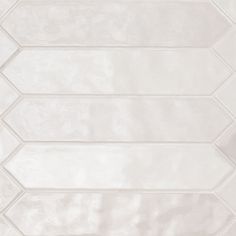 a white tiled wall with four lines in the middle