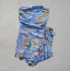 Turn heads in this stunning strapless wrap style romper – we're obsessed with its abstract design that transitions effortlessly from day to night. 60% Rayon, 40% viscose; Lining 100% Cotton Model wearing size small Strapless Tropical Print Summer Dress, Strapless Summer Romper For Day Out, Strapless Summer Jumpsuits And Rompers For Day Out, Strapless Jumpsuit For Summer Beach, Strapless Jumpsuits And Rompers For Summer Day Out, Strapless Printed Mini Dress For Summer, Summer Strapless Jumpsuit For Day Out, Floral Print Strapless Jumpsuit For Summer, Chic Strapless Floral Print Jumpsuits And Rompers