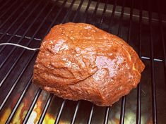 a piece of bread is cooking on the grill with it's wire attached to it