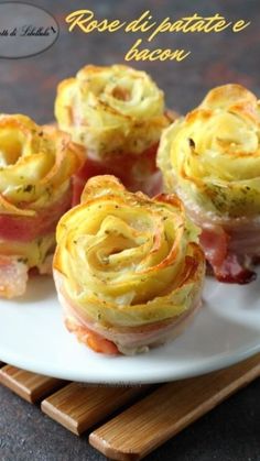 small appetizers with ham and cheese are on a white plate next to chopsticks