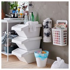 there are many containers stacked on top of each other in this room, and one is filled with toilet paper